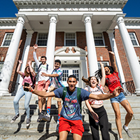 Students jumping outside Brockway Hall